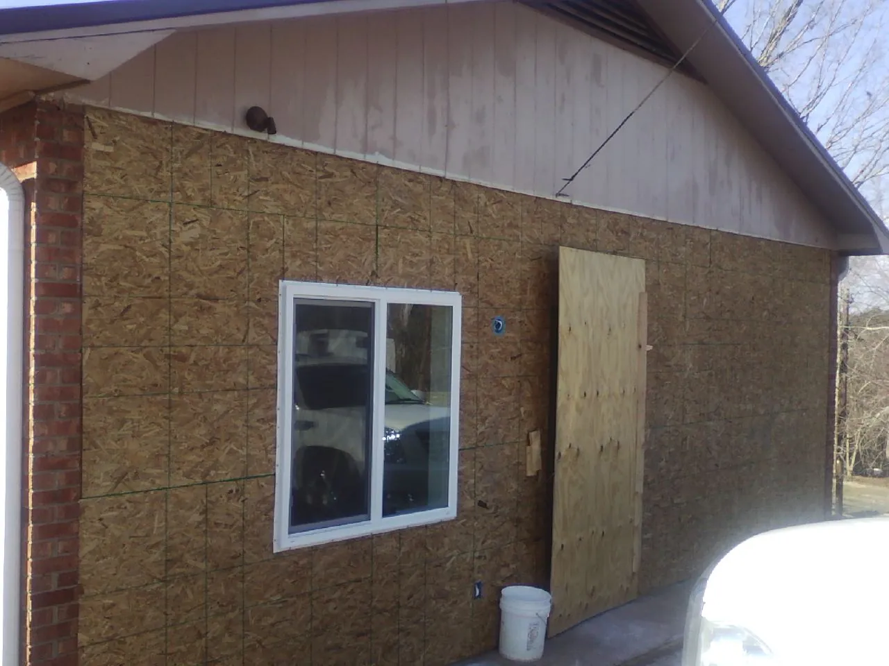 OSB sheathing on a garage addition wall before siding in Kingston